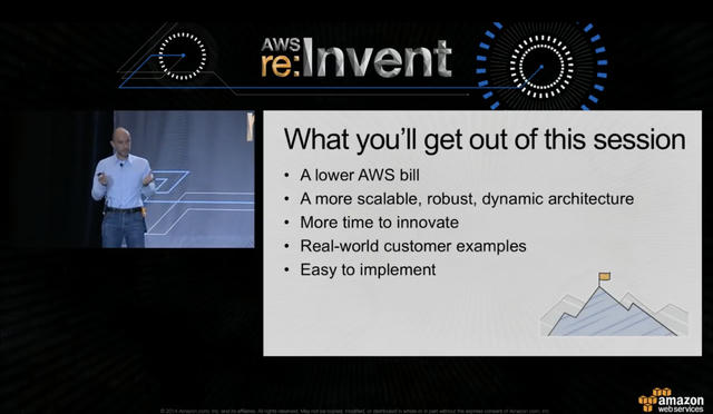 AWS re:Invent 2014 conference slide showing Constantin in a light blue shirt standing on stage. The slide title reads “What you'll get out of this session” with five bullet points: A lower AWS bill, A more scalable, robust, dynamic architecture, More time to innovate, Real-world customer examples, and Easy to implement. A mountain with a flag icon appears in the bottom right corner of the slide.