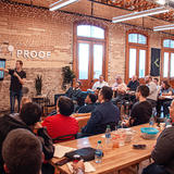 A co-working space with someone presenting to a group